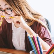 Lady biting a pencil in frustration.